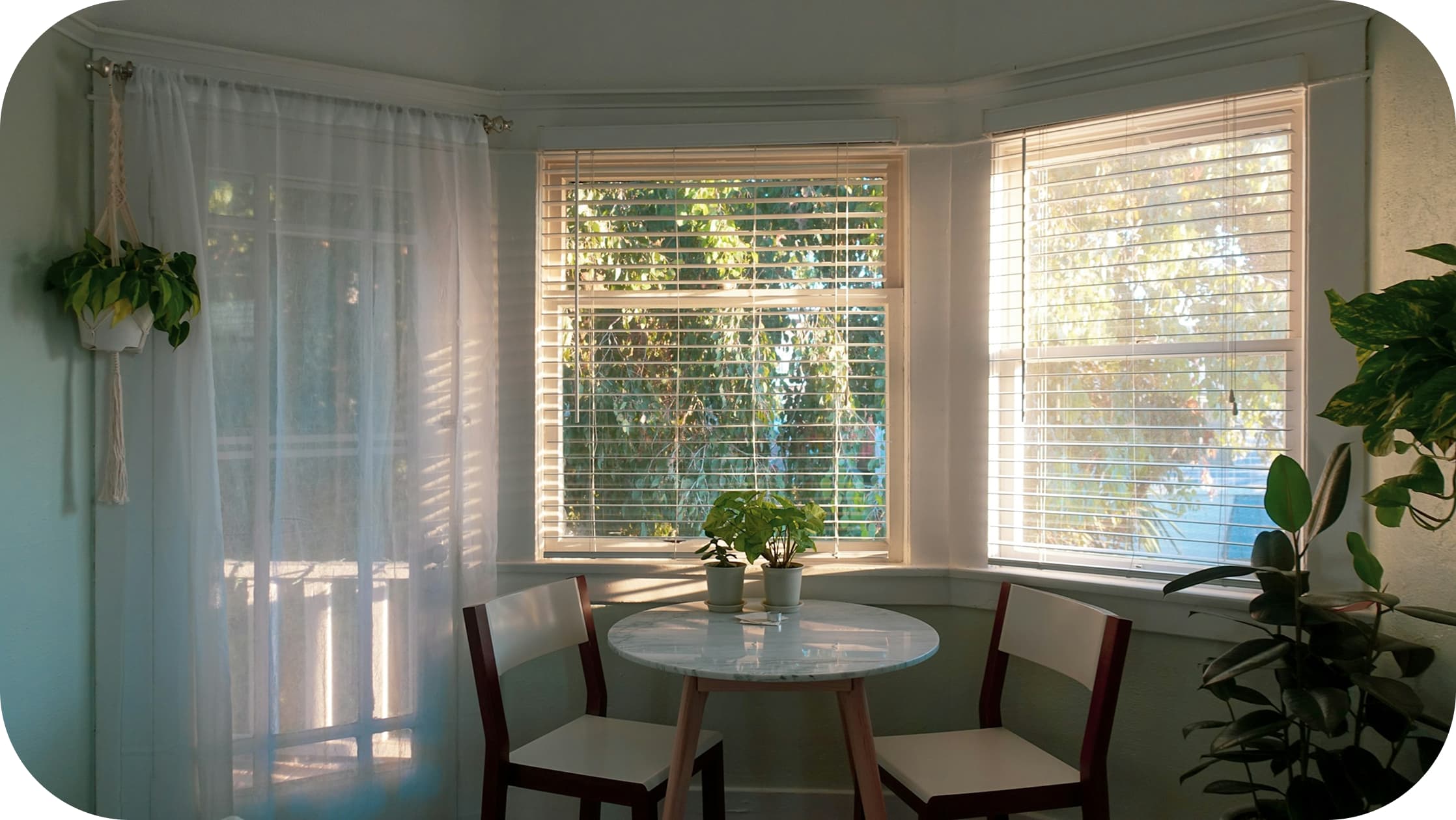 Image of a kitchen with a window covered by a curtain