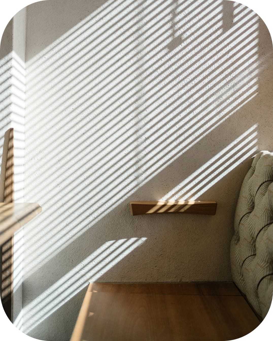Image of a window with curtains and sunlight coming through
